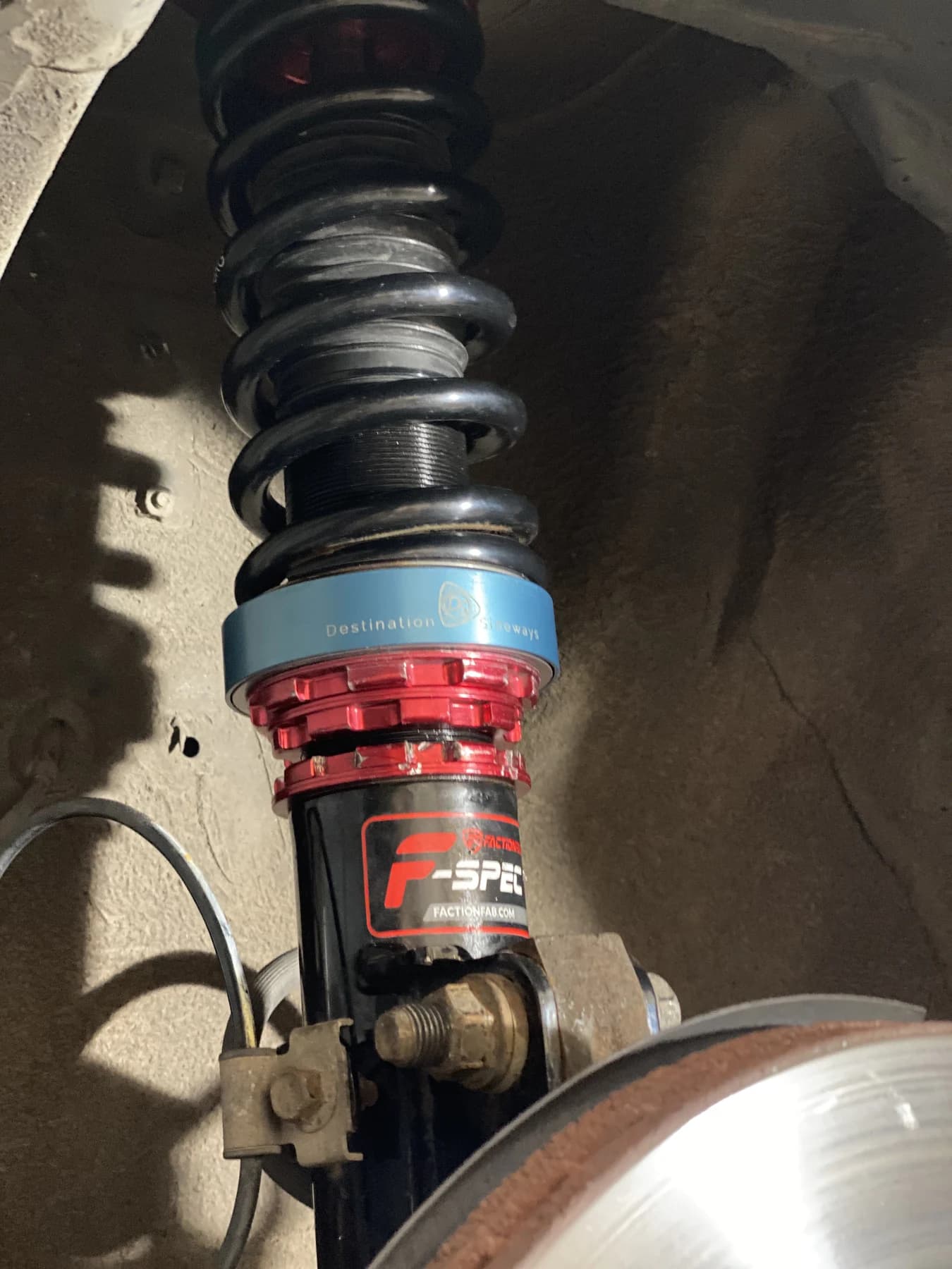 Blue V1 adapter installed beneath a black spring above the red collar after the collar lip modification.